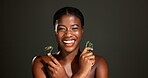 Gua sha, beauty and portrait of black woman in studio for smooth skin, facial and lymphatic drainage. Space, dark background and person with jade roller for health, skincare treatment and dermatology