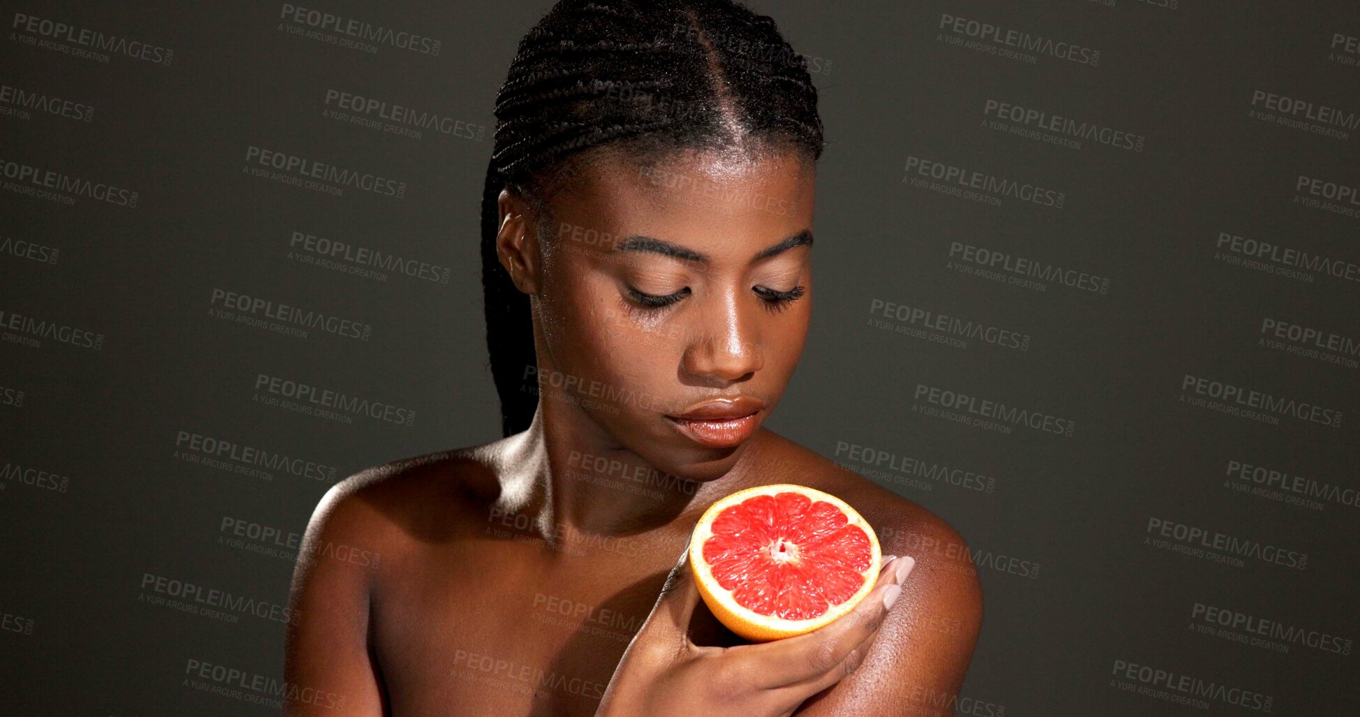 Buy stock photo Black woman, grapefruit or beauty with skincare in studio for skin detox on a dark background. Female person, model and natural organic fruit for antioxidant, vitamin C or body health on mockup space