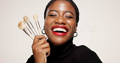 Buy stock photo Studio, happy and woman with makeup brush, confident or equipment for beauty, makeover and selfcare. White background, black person and cosmetic for self expression, creative and tools for foundation