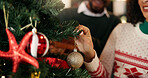 Decoration, Christmas tree and hands of couple in home for bonding, tradition and holiday. December, love and woman with shiny bauble, ornament and hanging for celebration, festive season and xmas