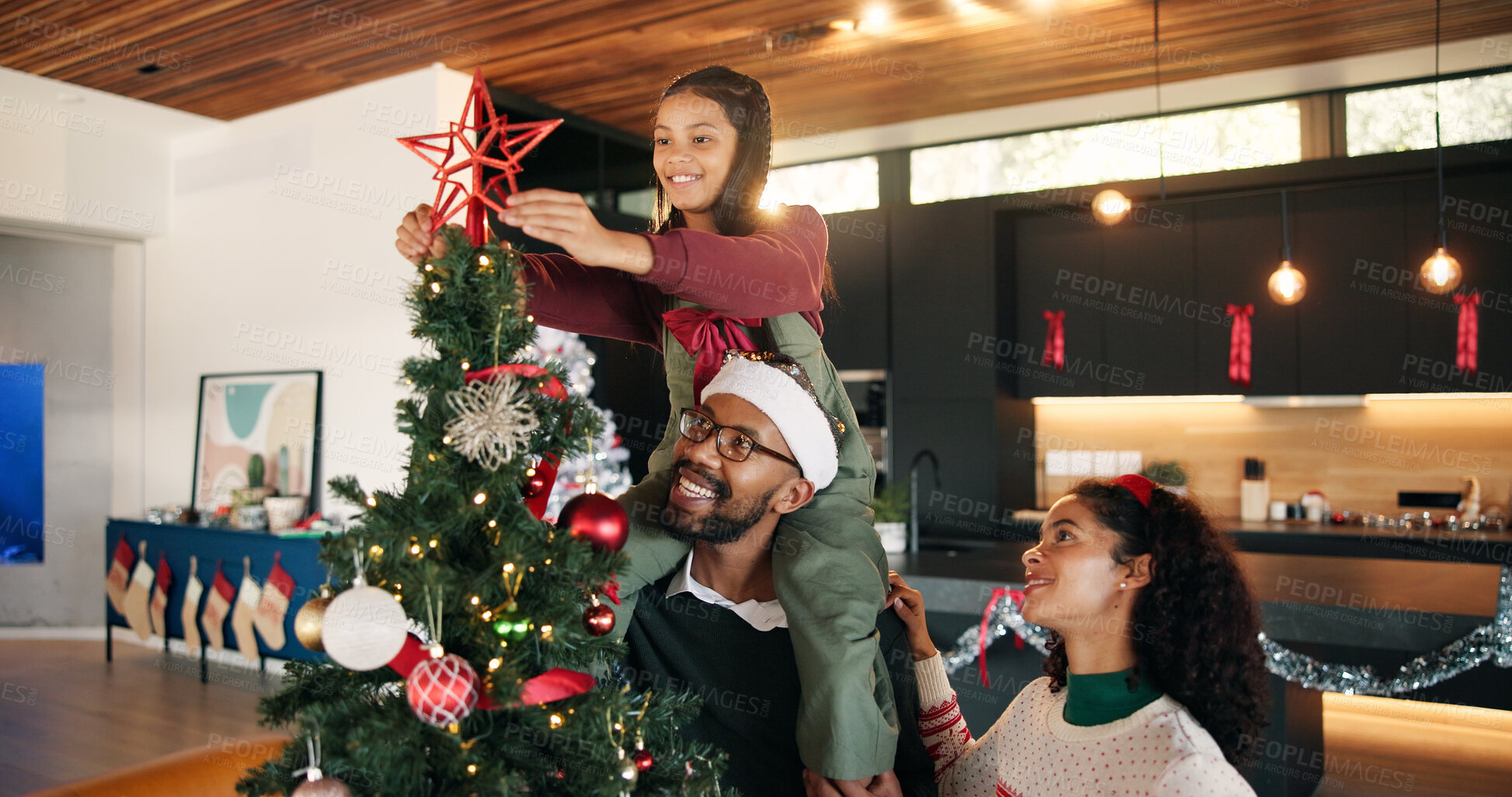 Buy stock photo Christmas tree, decoration and child with parents in home for bonding, tradition and holiday. December, black family and happy girl, mom and dad with star for celebration, festive season and xmas