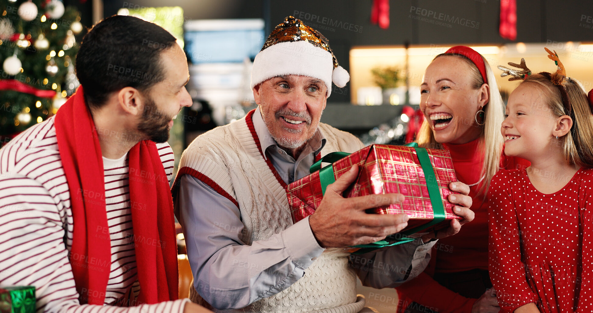 Buy stock photo Xmas, home and family in lounge, present and excited with celebration, funny and festive. Gratitude, laughing and Christmas with people, gifts and giving with surprise, holiday season and tradition