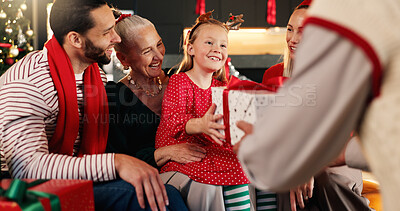 Buy stock photo Christmas, home and family with present, girl and excited with smile, holiday season and giving. Surprise, package and Xmas with people, gifts and celebration with happiness, festive or tradition