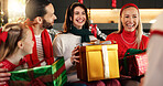 Christmas, home and family with present, tradition and excited with love, celebrate together and giving. Group, surprise and Xmas with people, gifts and wow with happiness, holiday season or smile