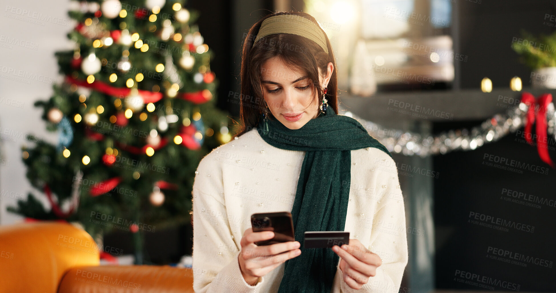 Buy stock photo Woman, reading and phone with credit card on Christmas for online shopping, gift search and purchase. Female person, bokeh and mobile for ecommerce, present checkout and xmas transaction at house