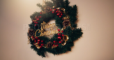 Christmas, home or decor with wreath for festive holiday or celebration on a wall background. Empty, space and round hanging object with tinsel for merry december, new year or christian decorations