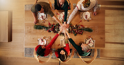 Buy stock photo Stack of hands, christmas and people in home for bonding, celebration or event in dining room. Gathering, festive season and family with connection for xmas party in house together from above.