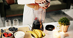 Hands, blender and strawberry for smoothie in kitchen for nutrition, vitamin c and detox for wellness. Person, fruits and process for milkshake, diet or benefits with healthy drink at apartment