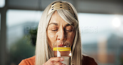 Buy stock photo Lemon, water and mature woman in home with drink for detox, antioxidant and vitamin c in morning. Glass, diet and person with liquid, citrus fruit and minerals for digestion, wellness and nutrition
