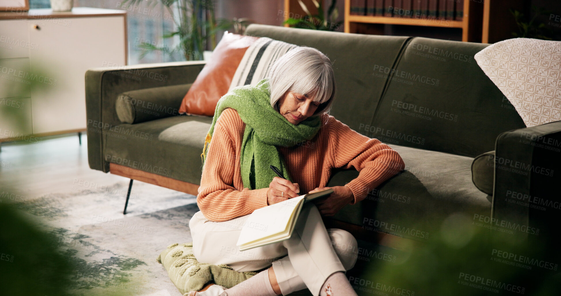 Buy stock photo Mature woman, writing and sofa with book for story, novel or author with chapter in home. Female person, writer or novelist with notebook for storytelling, journalism or publish article in house 