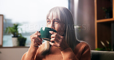 Buy stock photo Senior woman, drinking coffee and thinking on sofa with nostalgic memory, daydreaming or wondering. Retirement, relax and old person with warm beverage in home for wellness and reflection in lounge