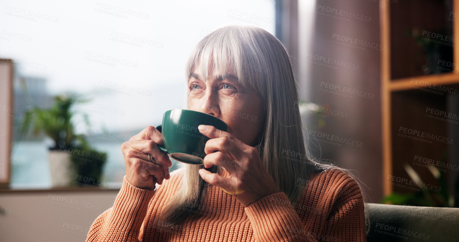 Buy stock photo Senior woman, drinking coffee and thinking on sofa with nostalgic memory, daydreaming or wondering. Retirement, relax and old person with warm beverage in home for wellness and reflection in lounge