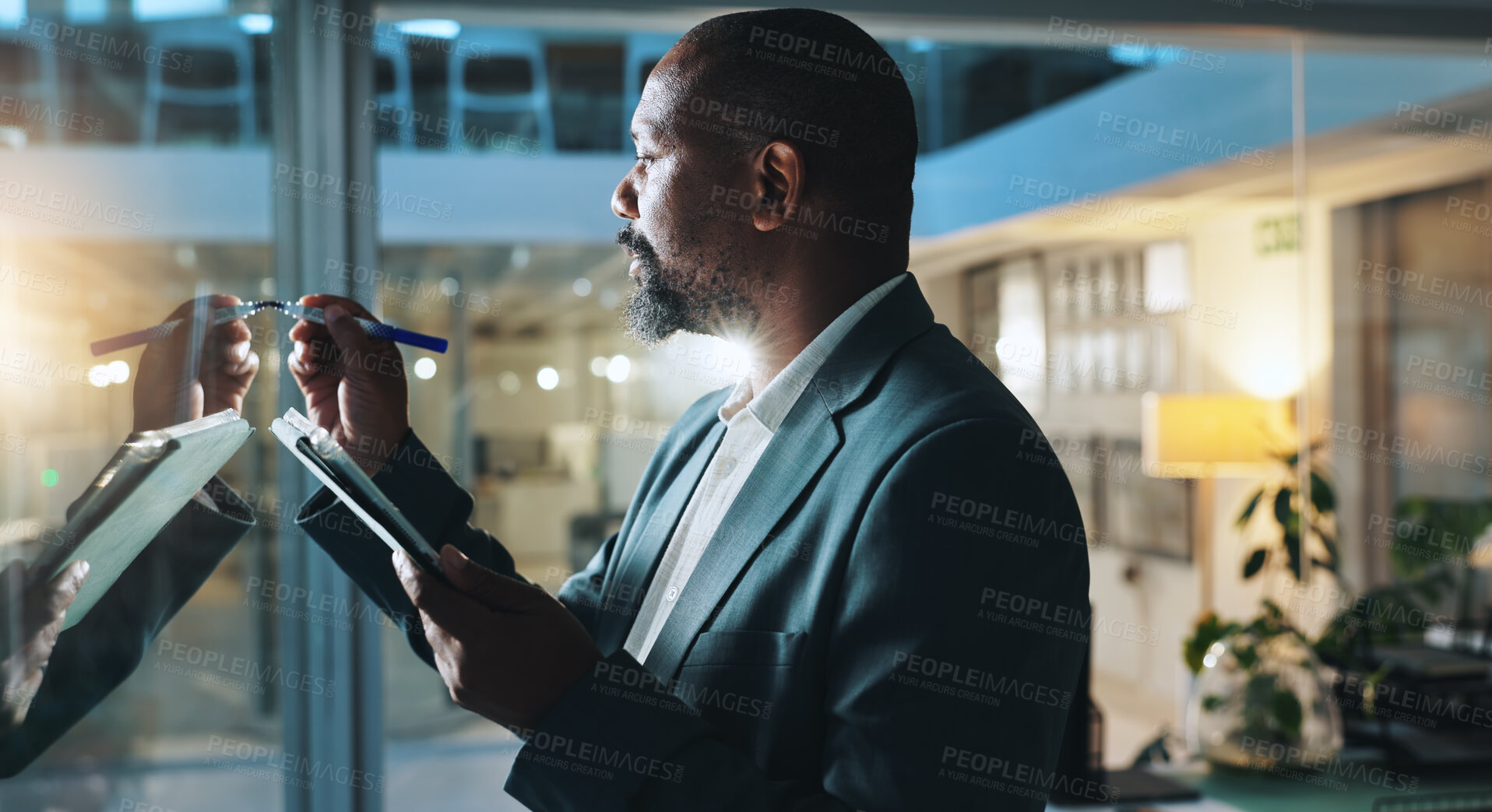 Buy stock photo Writing, planning and business black man on tablet for research notes, schedule and project management. Night, corporate and worker on digital tech by glass for ideas, report and strategy in office