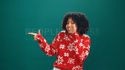 Buy stock photo Christmas, pointing and whisper with portrait of woman in studio for holiday season, celebration and promotion. Festive deals, xmas and announcement with person on green background space with mockup