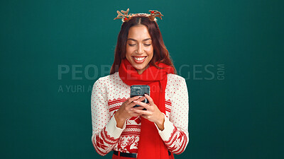 Buy stock photo Happy, woman and online shopping with smartphone, Christmas or search for gift, mockup space or web. Green background, studio and person with Xmas sweater, mobile app or scroll for holiday discount