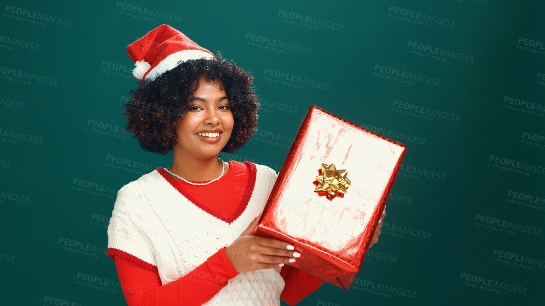 Buy stock photo Christmas hat, portrait and black woman with gift in studio for tradition, festive or celebration. Happy, holiday and African female person with present box for xmas event by green background.