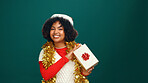 Santa hat, portrait and black woman with present in studio for christmas tradition, festive or celebration. Happy, holiday and African female person with gift box for xmas event by green background.