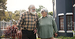 Happy, outdoor and senior couple walking and holding hands for fresh air, bonding and relax in garden. Retirement, nursing home and elderly man and woman in nature for peace, love and assisted living