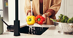 Water, hands and woman in kitchen, vegetables and cleaning with nutrition, washing and wellness. Closeup, home and person with natural ingredients, healthy and bell pepper with fresh food and cooking