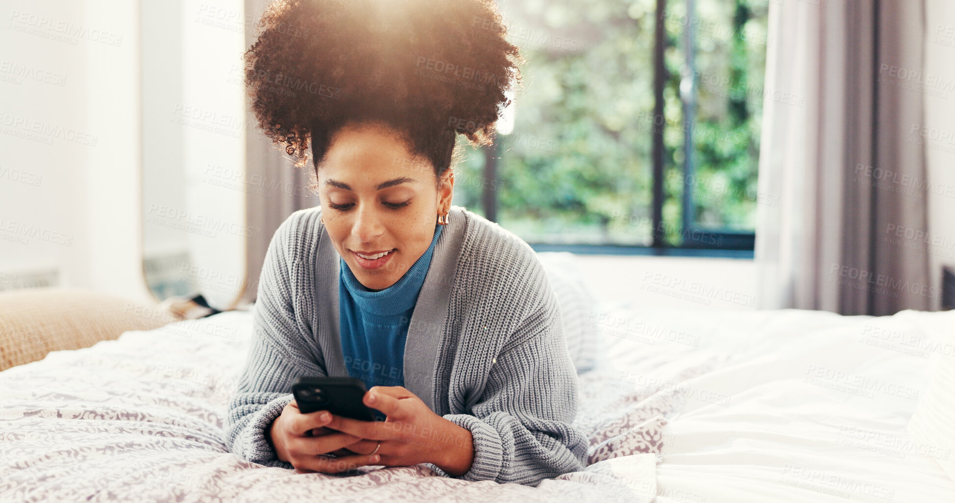 Buy stock photo Happy, relax and woman with phone on bed for social media, networking and online chat in home. Smile, bedroom and African person on smartphone for connection to internet, mobile app or typing message