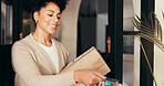 Woman, credit card and box for delivery with pos, payment and logistics service at home. Debit, customer and purchase package with courier at front door for order, shipping and smile for transaction