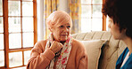 Conversation, home and caregiver with senior woman on sofa for diagnosis and treatment plan. Healthcare, discussion and medical nurse with elderly female person for checkup in living room at house.