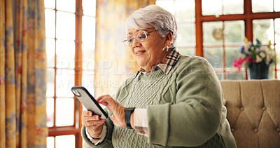 Buy stock photo Senior woman, scroll or phone on sofa for online news, playing word search or reading ebook. Retirement, relax and old person with smartphone in home for streaming service, internet games or browsing