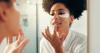 Buy stock photo Mirror, skincare and woman with lip balm, grooming or shine with eye patch, beauty and home. Reflection, African person and routine for anti aging, makeup and cosmetics for skin glow in bathroom