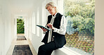 Mature woman, reading and tablet at house for research, email client and selling property. Female realtor, digital and website for real estate sales, review information and schedule viewing of rental