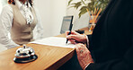 Hands, document and signature at hotel, writing or registration for accommodation at resort. People, check in and paperwork with client, concierge or help desk for suite booking at hospitality lodge