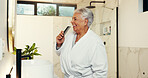 Senior woman, singing and brush in bathroom with music, getting ready and karaoke concert. Elderly person, sound and comb for fun entertainment, grooming routine and playlist for performance at house