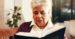 Relax, reading and senior woman with bible in home for worship, faith and spiritual wellness. Christian, religion and elderly female person with studying holy book for learning gospel in living room.