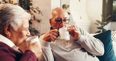 Buy stock photo Coffee, drinking and senior couple on sofa in home with conversation, bonding or relaxing together. Happy, tea and elderly man with woman for retirement in living room for calm morning in house.