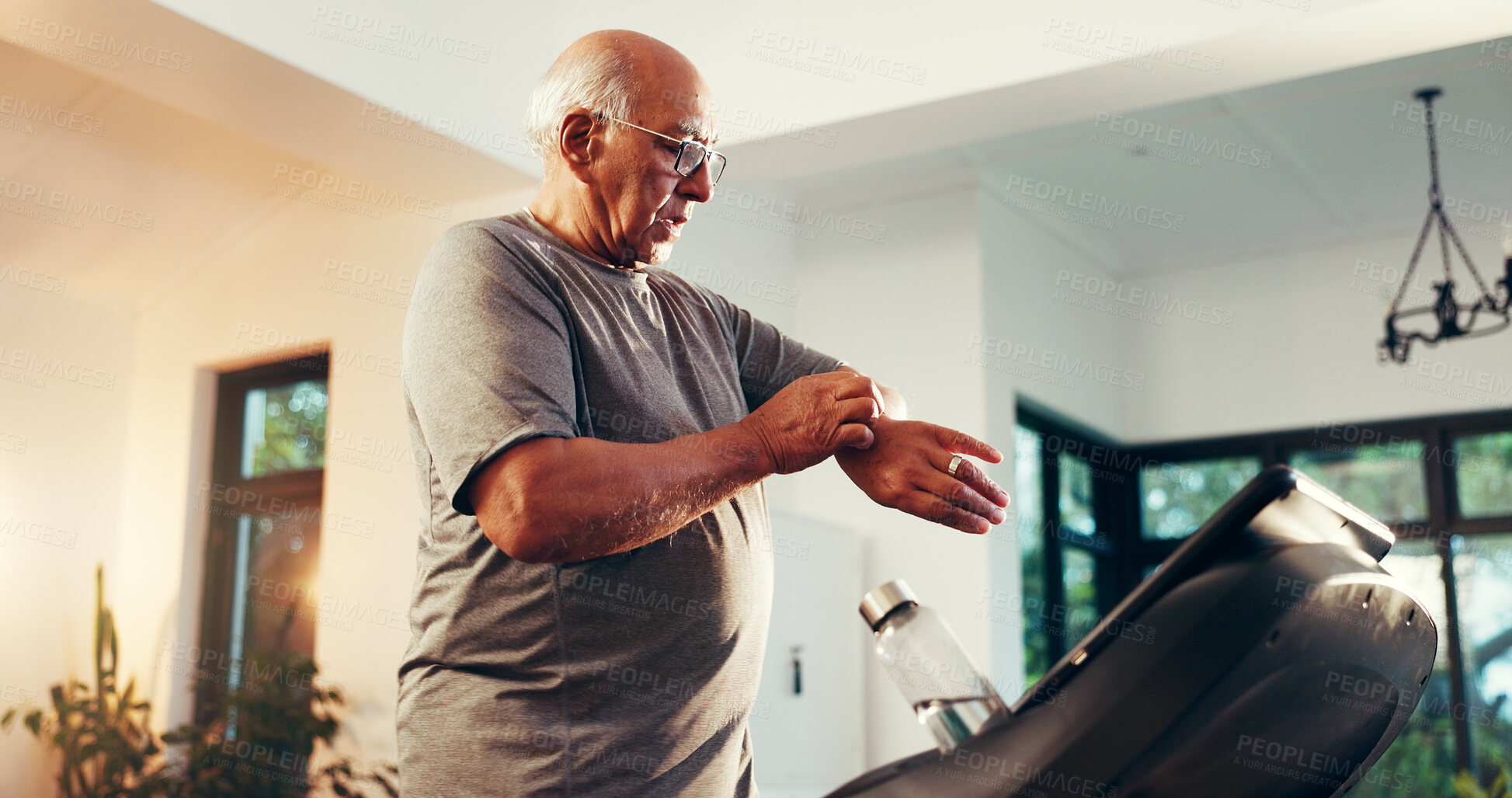 Buy stock photo Senior man, treadmill or check watch in home for walking speed, cardio stats and performance. Retirement fitness, elderly person and monitor stopwatch on machine for mobility wellness and heart rate