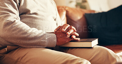 Buy stock photo Faith, hands and bible with old man on sofa for worship, gratitude and peace. Praying, spiritual connection and religion with person and book in living room of home for trust, holy text and belief