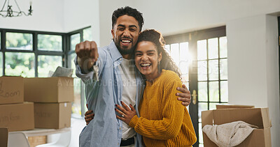 Buy stock photo Hug, keys and moving with couple in new home for property, support and mortgage success. Real estate investment, celebration and relocation with portrait of man and woman in living room of house