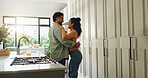 Laughing, couple and hug in kitchen, love  or bonding on break in house, commitment or relationship. Happy, man and embrace with woman in home, affection and romance in apartment, care or marriage