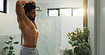Muscle, stretching  and mirror with man in bathroom for morning routine, workout transformation and health. Self care, bodybuilder pride and wellness with male person in home for body and progress