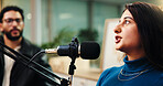 Podcast, studio and woman with mic talking for radio show, interview and broadcast subscription. Influencer, content creation and man with guest for interview, conversation and host on live stream