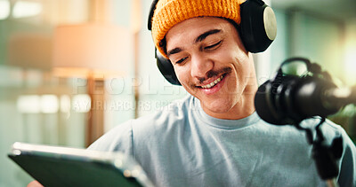 Buy stock photo Content creation, influencer and man with mic, tablet or reading script for episode, talking or app. Live streaming, podcaster and person with tech for entertainment, online and host with headphones