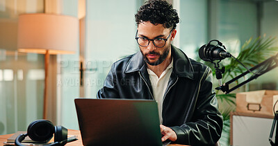Buy stock photo Mic, laptop and man in studio for podcast, broadcast and editing talk show at media agency. Radio producer, content creation and person on computer for planning script, interview and notes for host