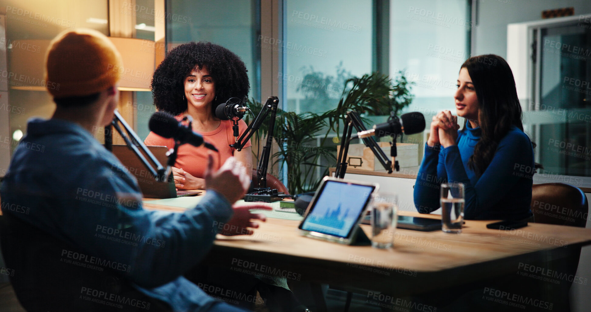 Buy stock photo Podcast, talking and man with women in studio with questions for interview, discussion and conversation. Content creation, host and people with mic for recording radio show, broadcast and live stream