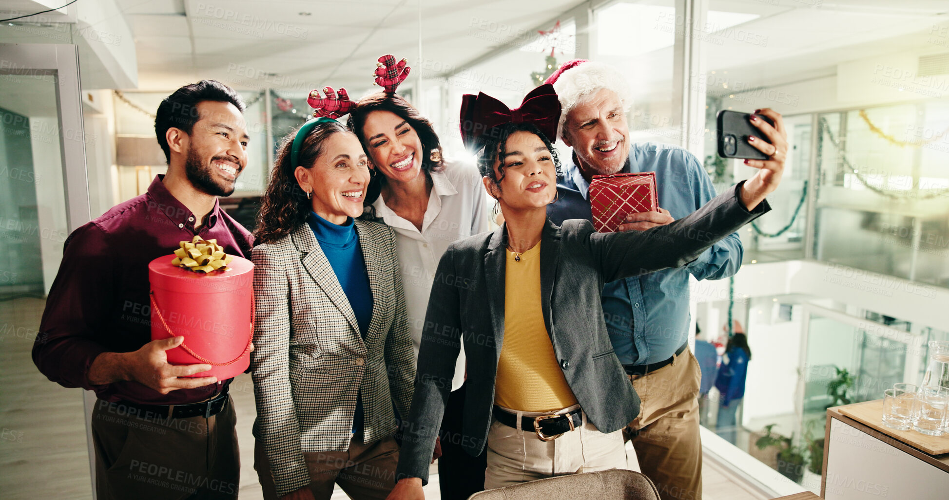 Buy stock photo Christmas, business people and team selfie in office for photography with gift. Xmas picture, friends and happy workers with holiday spirit, December celebration or memory for social media at party