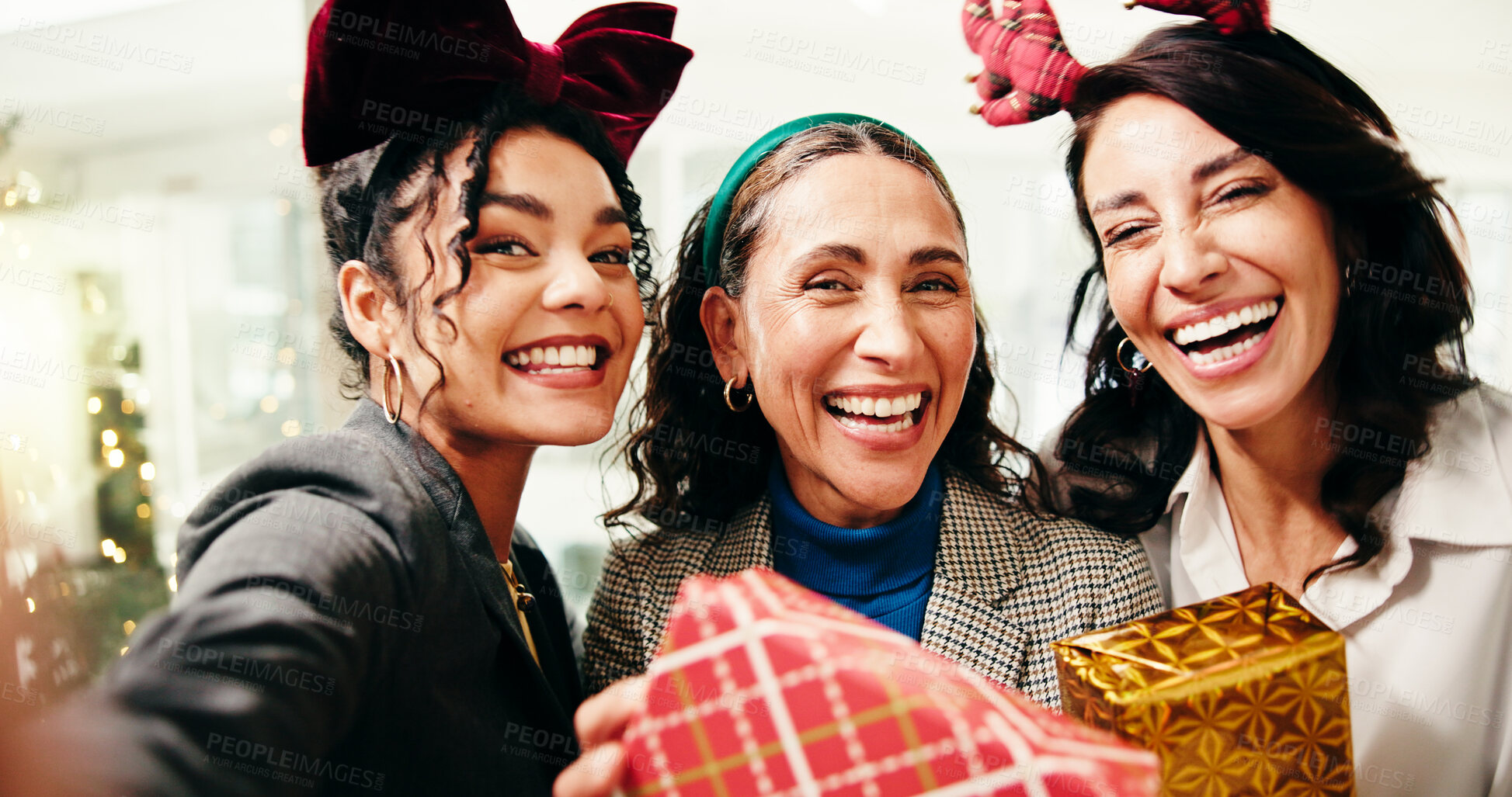 Buy stock photo Christmas, business women and group selfie with gift at festive celebration with POV in office. Team, portrait and photo of friends with xmas present for holiday, party or laugh for social media post