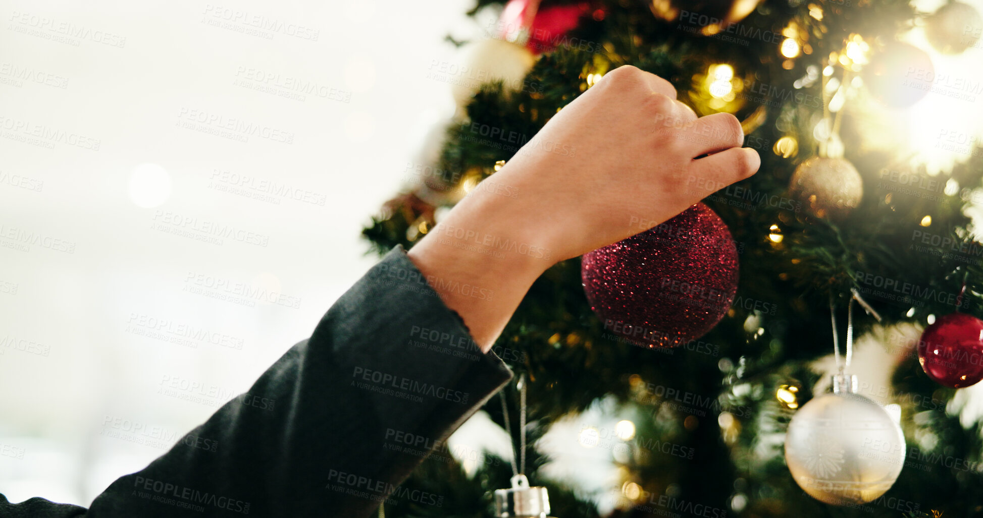 Buy stock photo Christmas tree, decoration and hand of person in home for celebration or December holidays. Bauble, glitter and hanging with woman in living room of apartment for festive season or tradition space