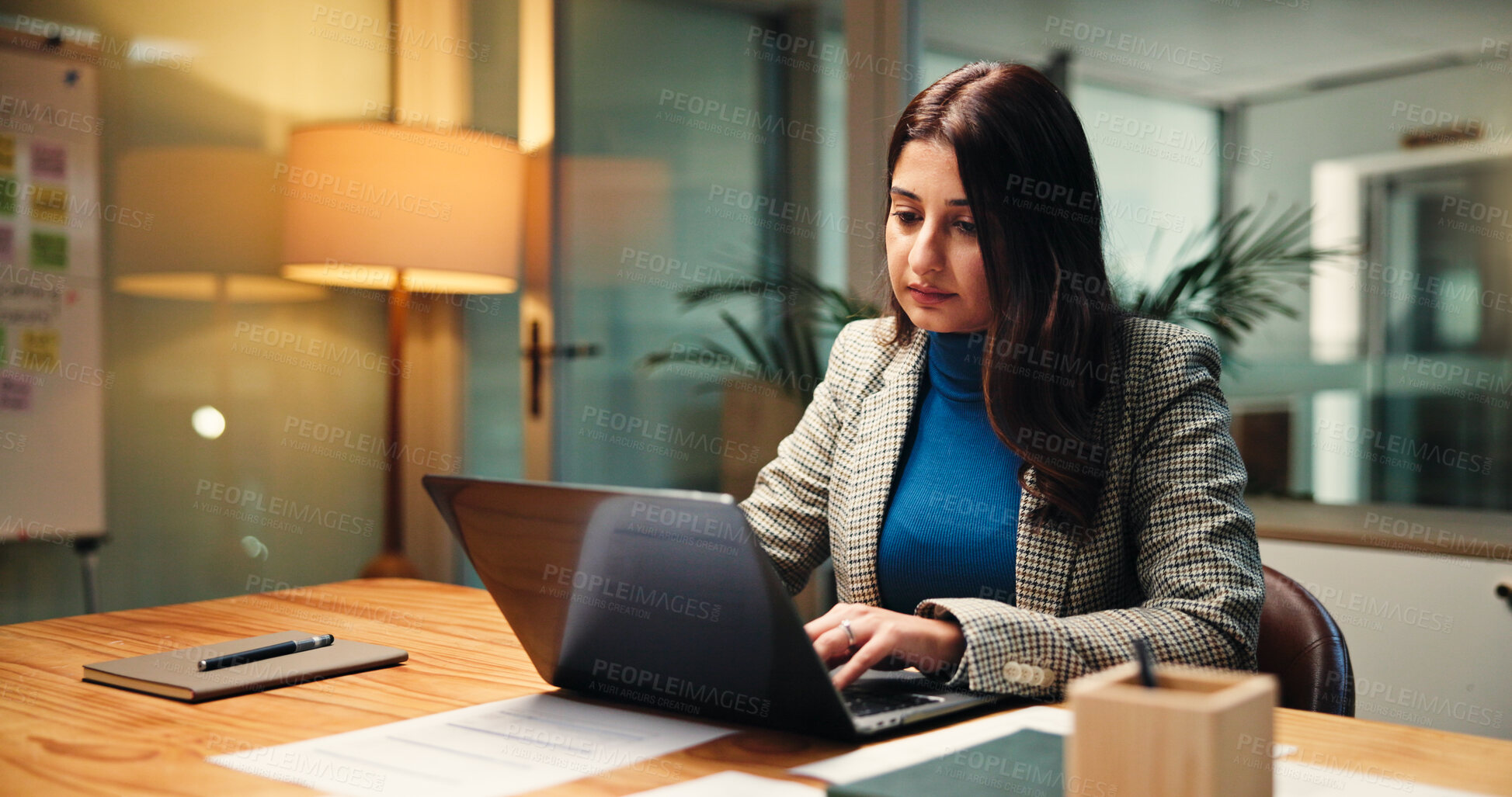 Buy stock photo Laptop, night and planning with business woman in office for finance, investment or report deadline. Computer, financial review and typing with Indian employee at desk in workplace for accounting