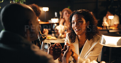 Buy stock photo Conversation, date and holding hands with couple in restaurant at night for bonding or celebration. Partner, romance and love with people together for anniversary, cuisine or relationship chat
