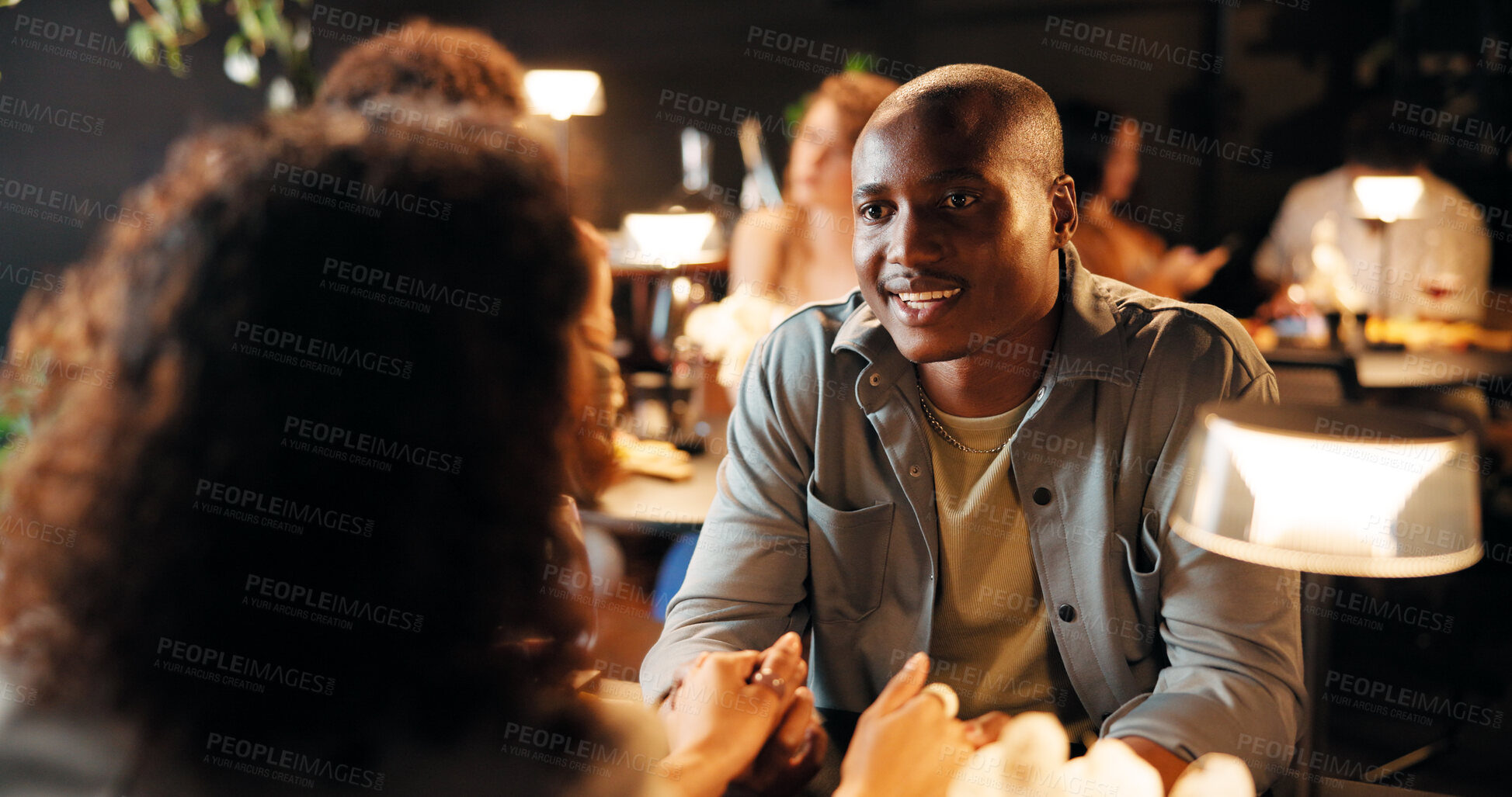 Buy stock photo Date, love and couple holding hands at restaurant for care, bonding or connection at night. Fine dining, man and woman with romance for relationship, marriage commitment and support with partner