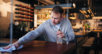 Buy stock photo Pub, bartender and cleaning with cloth for hygiene, dust and service for drinks at restaurant. Man, owner and check for dirt with spray bottle, shine and cafe with inspection at small business