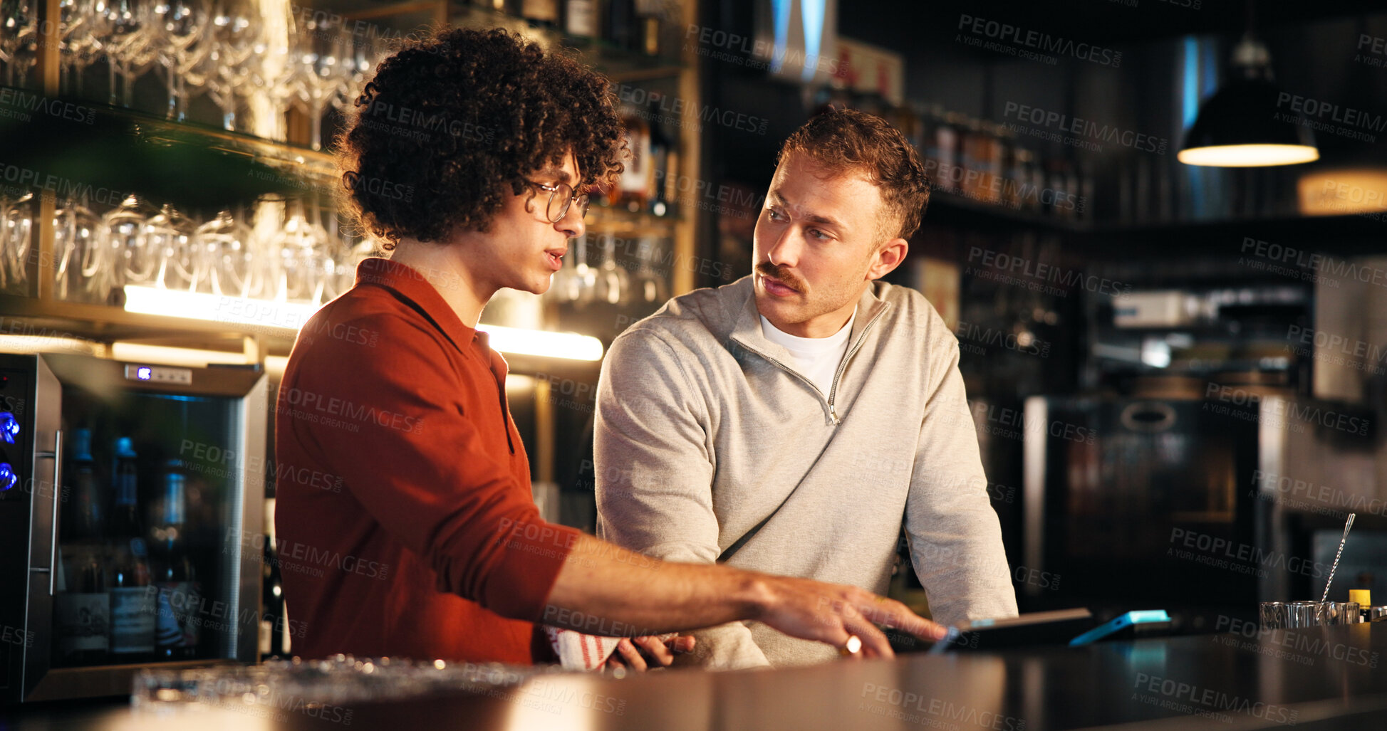 Buy stock photo Bar, manager and training with tech for order, teamwork and explaining system to employee and night. Pub, server and people with app to process transactions, working late or help with sales data